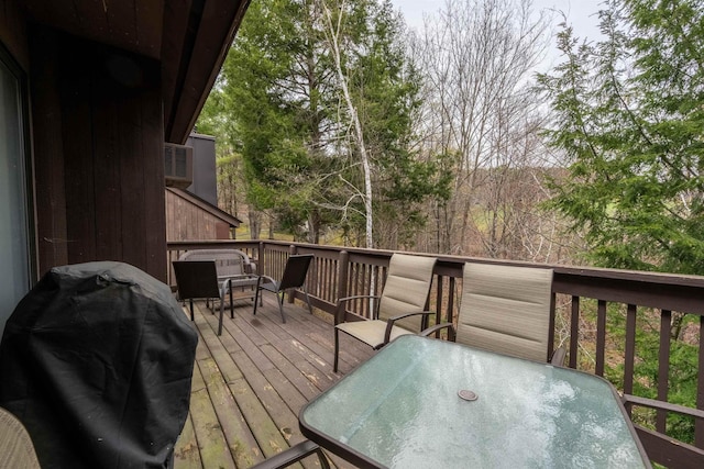 deck featuring outdoor dining area and area for grilling