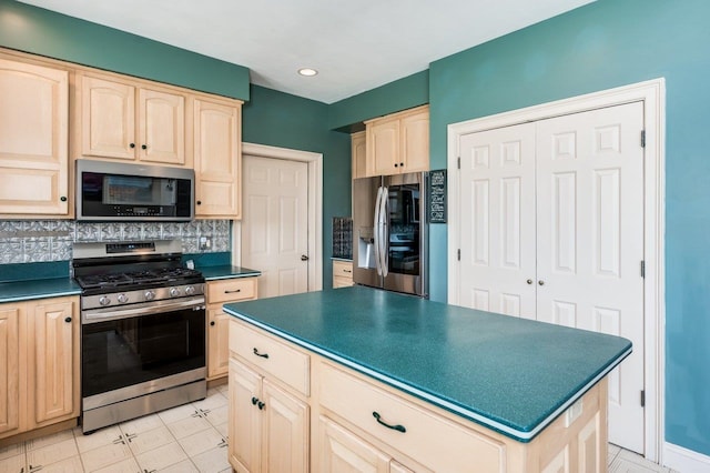 kitchen with light brown cabinetry, dark countertops, appliances with stainless steel finishes, and decorative backsplash
