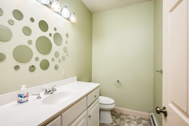 bathroom with vanity, tile patterned floors, toilet, baseboards, and baseboard heating