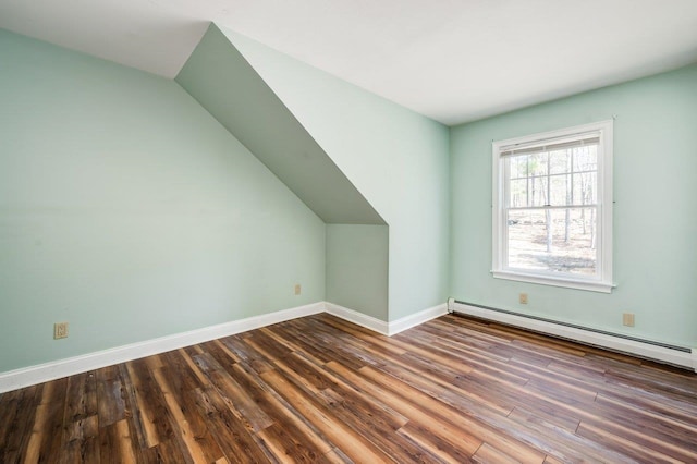 additional living space with lofted ceiling, baseboard heating, wood finished floors, and baseboards
