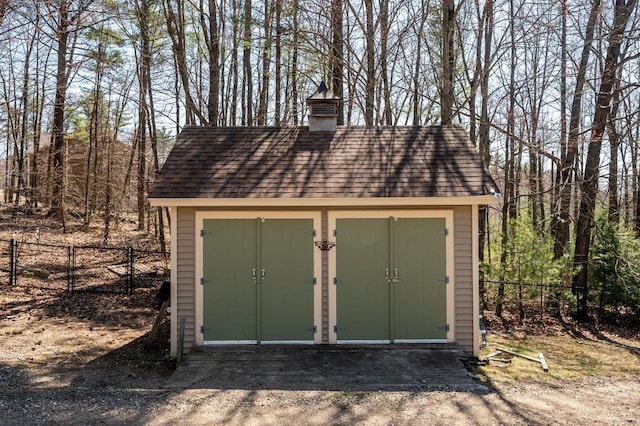 view of shed featuring fence
