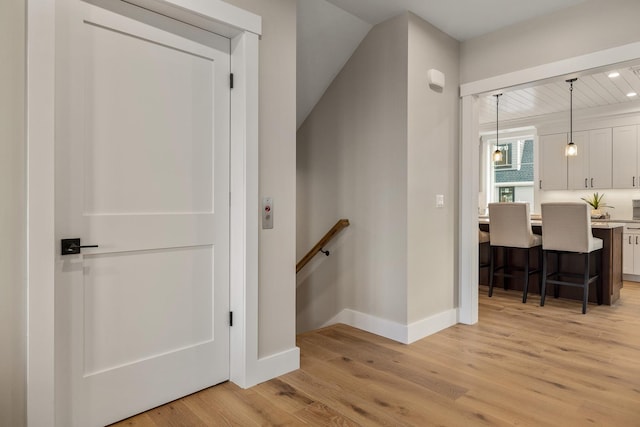 stairway featuring wood finished floors and baseboards