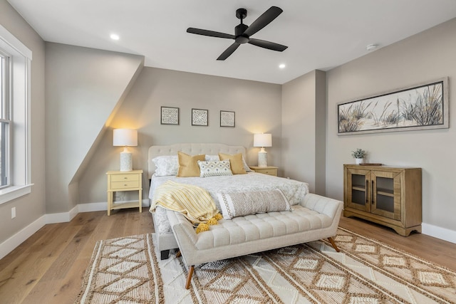 bedroom featuring wood finished floors, recessed lighting, and baseboards