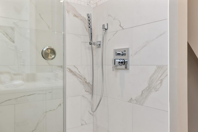 bathroom with a marble finish shower