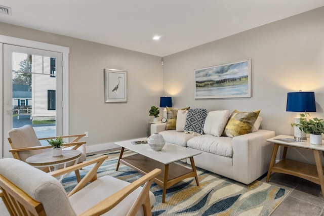 living room with recessed lighting, visible vents, and baseboards