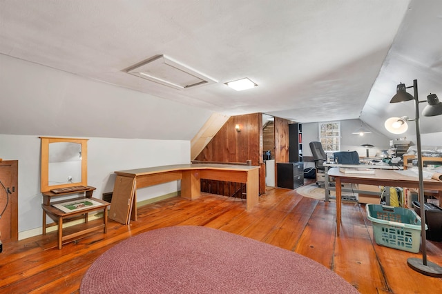 home office with hardwood / wood-style floors, attic access, and lofted ceiling