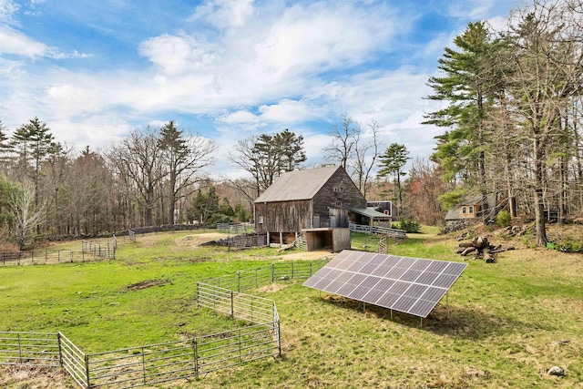 view of yard featuring fence and a barn