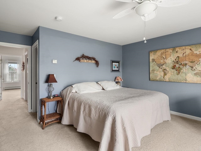 bedroom featuring baseboards, a baseboard radiator, ceiling fan, and light colored carpet