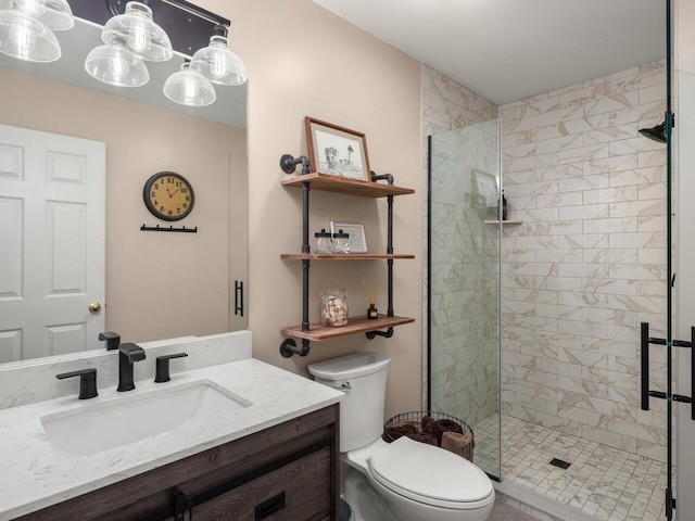 full bathroom featuring vanity, a shower stall, and toilet