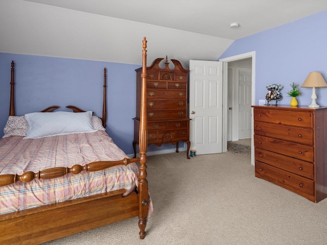 bedroom featuring vaulted ceiling and carpet