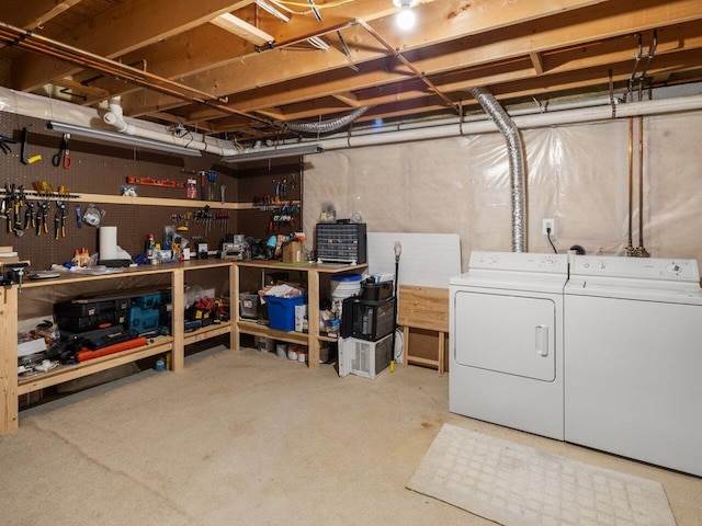 unfinished basement featuring washing machine and clothes dryer and a workshop area