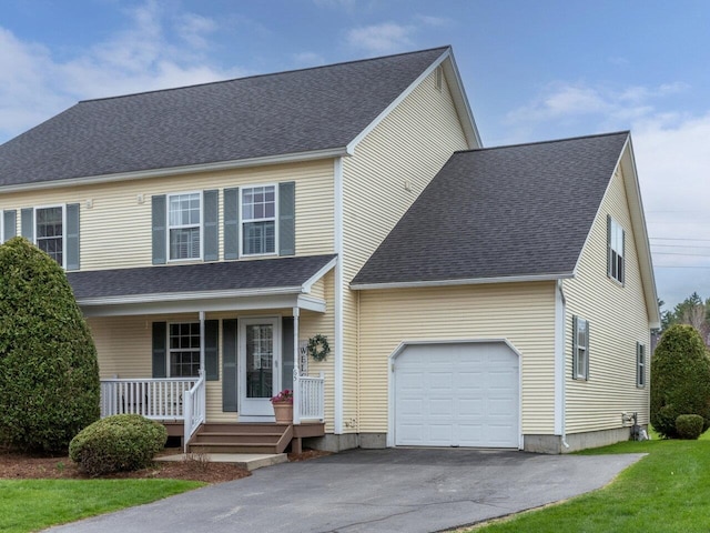 traditional-style house featuring a porch, a garage, driveway, and a shingled roof