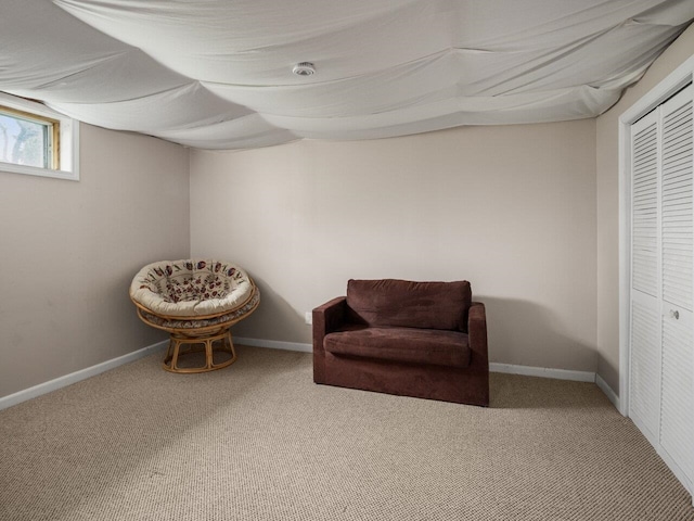 living area with baseboards and carpet flooring