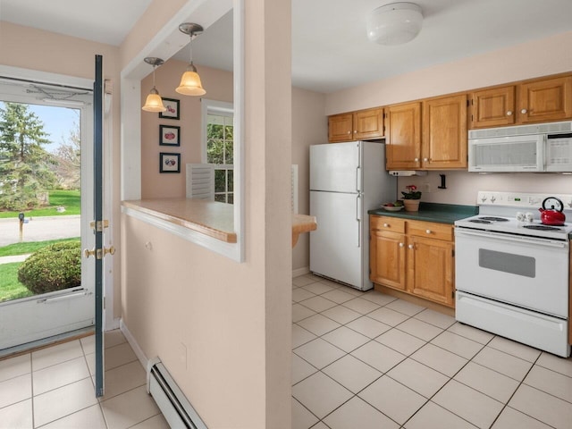 kitchen featuring plenty of natural light, light tile patterned floors, and white appliances