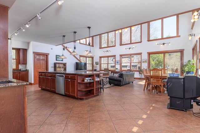 107-109 Baker Rd, Springfield, VT 05156 - kitchen with light tile patterned floors, open shelves, open floor plan, and stainless steel dishwasher