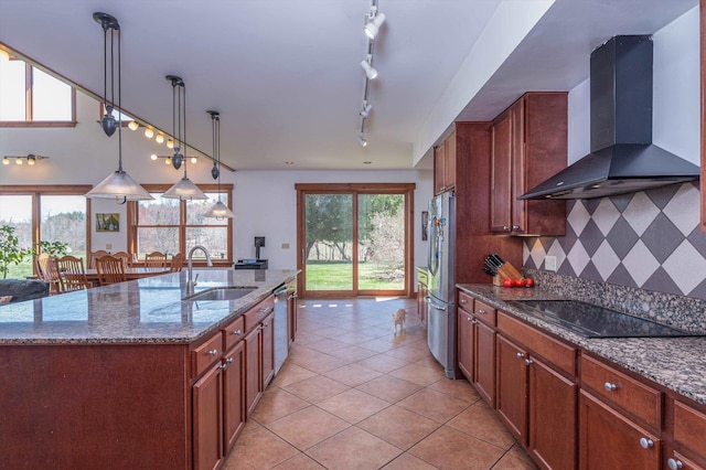 107-109 Baker Rd, Springfield, VT 05156 - kitchen featuring rail lighting, appliances with stainless steel finishes, a sink, wall chimney exhaust hood, and light tile patterned flooring