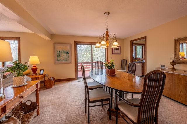 dining area featuring baseboards, light carpet, and an inviting chandelier