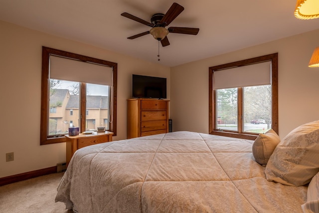 bedroom featuring a ceiling fan, carpet, and baseboards