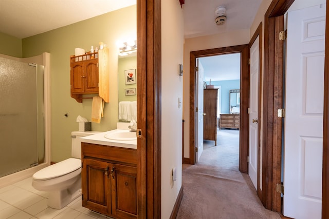 bathroom featuring toilet, vanity, and a stall shower