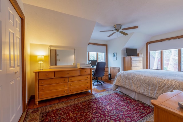 bedroom featuring wood finished floors, a ceiling fan, and vaulted ceiling