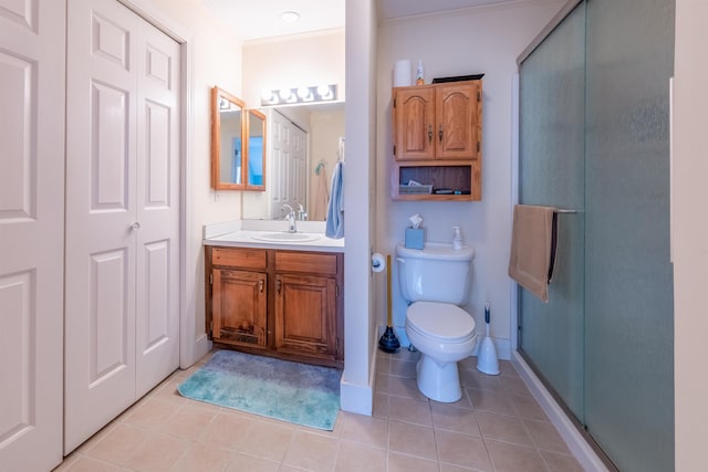 bathroom featuring a stall shower, toilet, ornamental molding, vanity, and tile patterned flooring