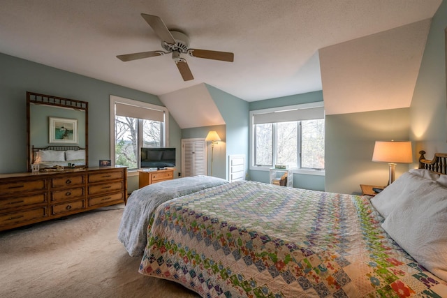 bedroom featuring a ceiling fan, vaulted ceiling, and light carpet