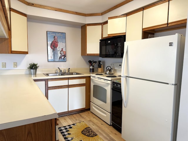kitchen with light wood-style floors, white appliances, light countertops, and a sink