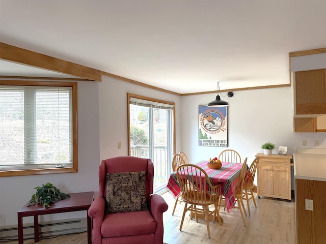 dining space with light wood-type flooring and a baseboard radiator