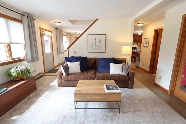 living room with a baseboard heating unit, light wood-style flooring, and a baseboard radiator