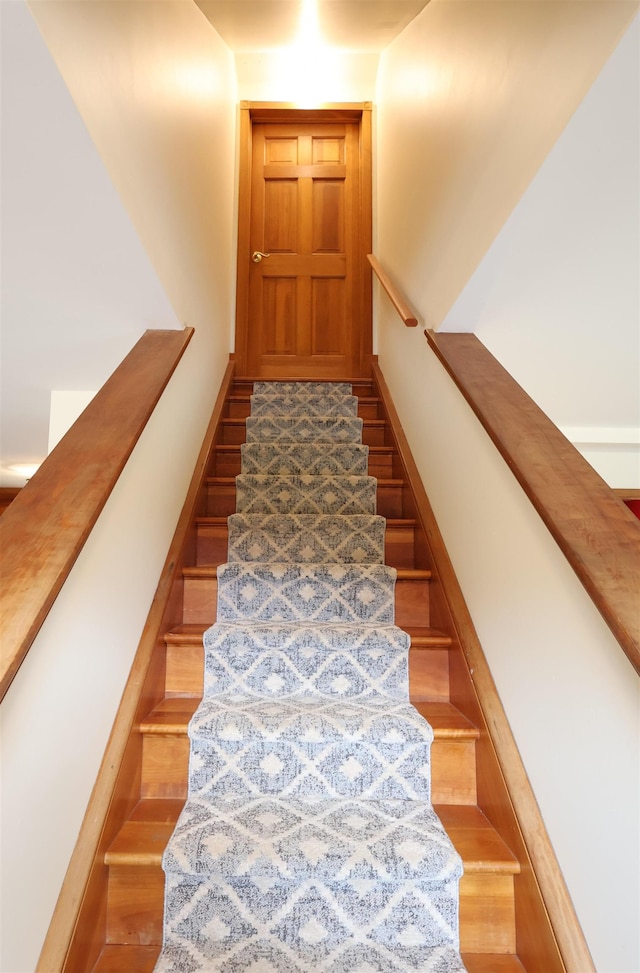 staircase featuring wood finished floors