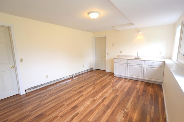 interior space with wood finished floors and a sink