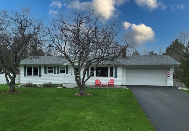 ranch-style home featuring a garage, a chimney, aphalt driveway, and a front yard