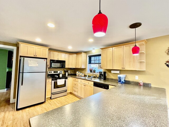 kitchen with a sink, dark countertops, light brown cabinets, decorative light fixtures, and white appliances