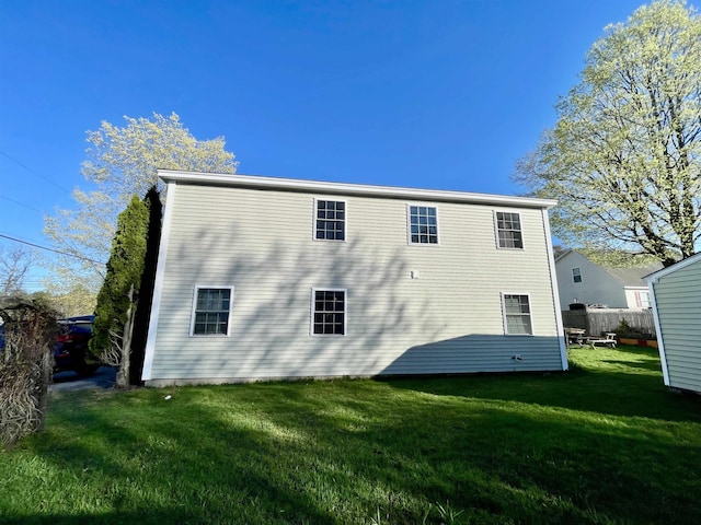 rear view of house with a yard