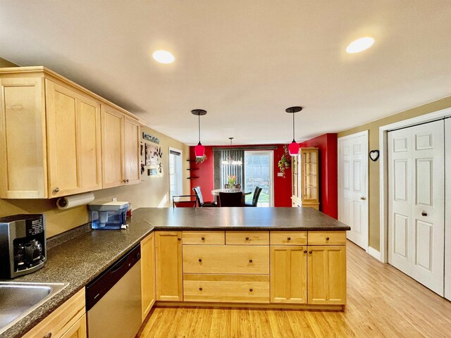 kitchen featuring dark countertops, light wood-style floors, light brown cabinets, a peninsula, and dishwashing machine