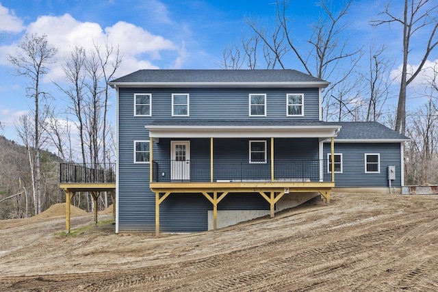 view of front of property featuring roof with shingles