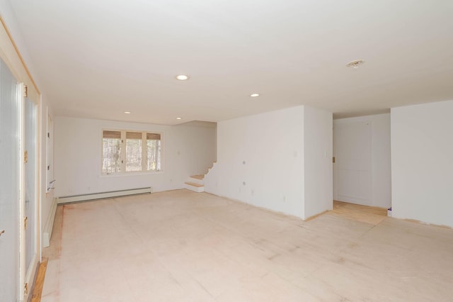 unfurnished room with recessed lighting, baseboard heating, and stairs