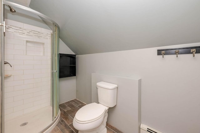full bathroom featuring lofted ceiling, a baseboard radiator, a stall shower, toilet, and wood finished floors
