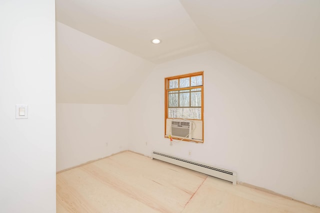 additional living space with cooling unit, lofted ceiling, and a baseboard radiator