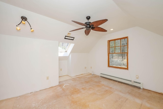 bonus room featuring ceiling fan, vaulted ceiling with skylight, and a baseboard radiator