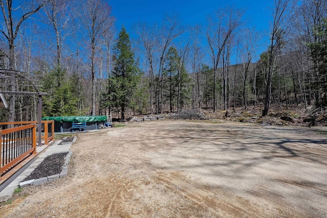 view of yard featuring a wooded view