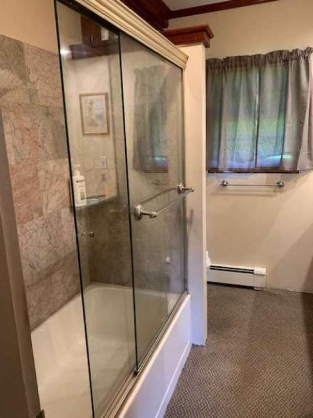 full bathroom with a baseboard heating unit and enclosed tub / shower combo
