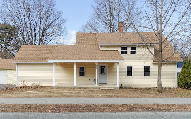 152 E St, Charlestown, NH 03603 - traditional-style house with a porch, a shingled roof, and a chimney