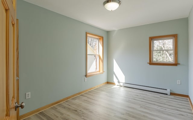 152 E St, Charlestown, NH 03603 - empty room with light wood-style floors, baseboards, and a baseboard heating unit