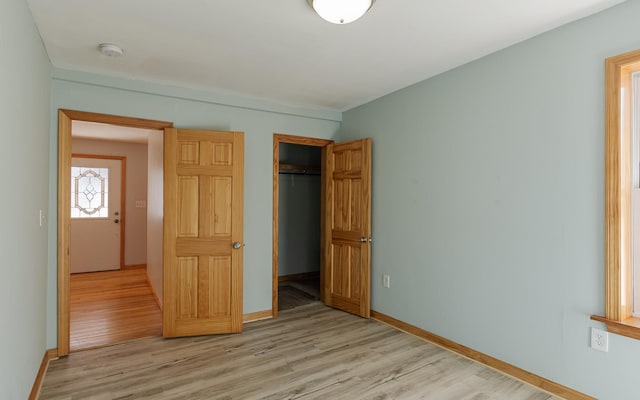 152 E St, Charlestown, NH 03603 - unfurnished bedroom featuring light wood-style floors, baseboards, and a closet