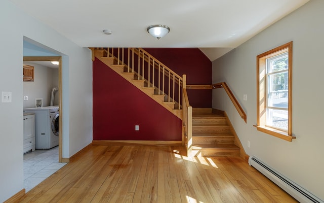 152 E St, Charlestown, NH 03603 - stairs with baseboards, a baseboard radiator, washer / clothes dryer, and hardwood / wood-style floors