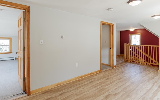 152 E St, Charlestown, NH 03603 - additional living space featuring baseboards, a baseboard heating unit, and light wood finished floors