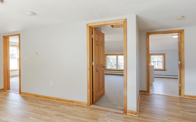 152 E St, Charlestown, NH 03603 - spare room with baseboards, light wood finished floors, a baseboard heating unit, and baseboard heating