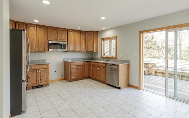 152 E St, Charlestown, NH 03603 - kitchen featuring brown cabinets, stainless steel appliances, recessed lighting, and a sink