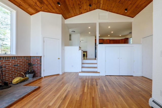 unfurnished living room with a wood stove, wooden ceiling, high vaulted ceiling, light wood-type flooring, and baseboard heating